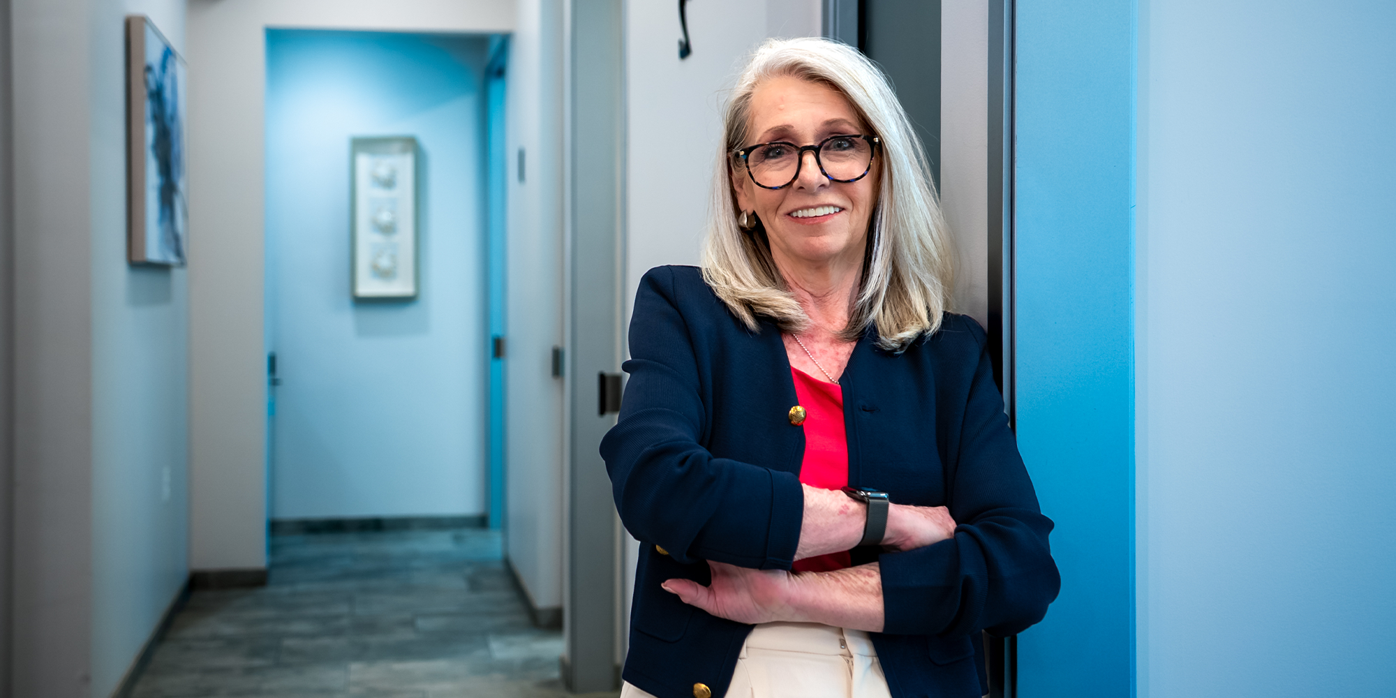 patient Deanne smiling in the hallway of the office